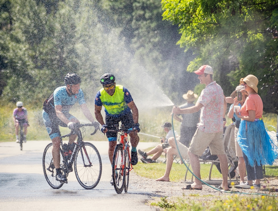 locals sprayed riders with garden hoses to keep them cool!
