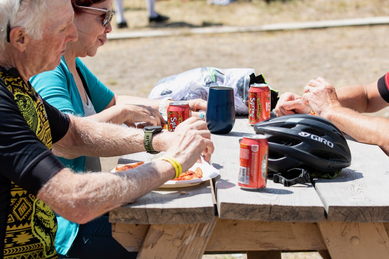 Riders returned to the finish area to enjoy hot pizza, cold drinks, and a relaxed afternoon in the park