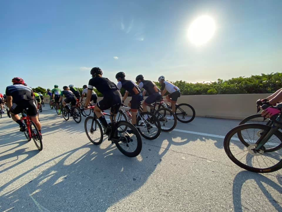 The peloton roll along Oceanside Drive with superb sunny sea views for maximum stoke!