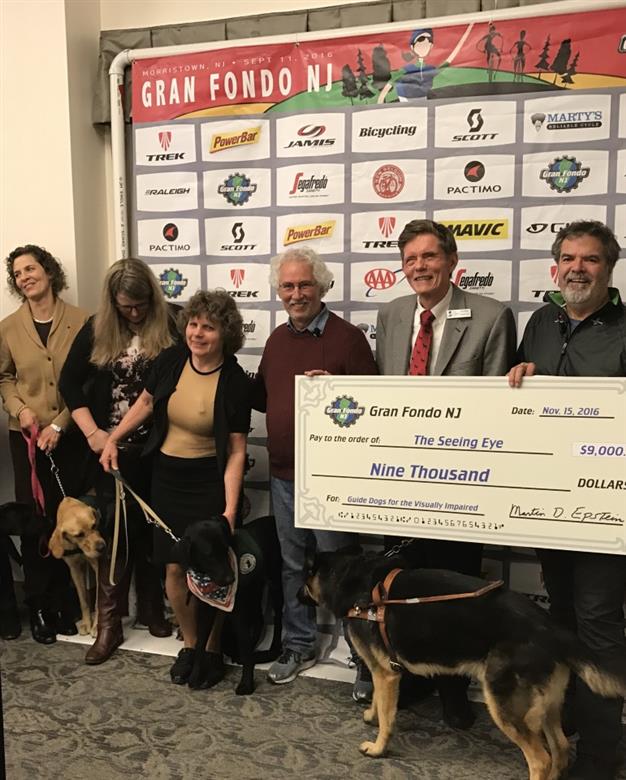 “The Seeing Eye” (Left to right)  Members of The Seeing Eye Puppy Raising Team and their charges, Marty Epstein, Founder of Gran Fondo NJ and Marty’s Reliable Cycle, Jim Kutsch, President and CEO of The Seeing Eye with his guide dog Vegas,  Bill Ruddick, Executive Director of Gran Fondo NJ.